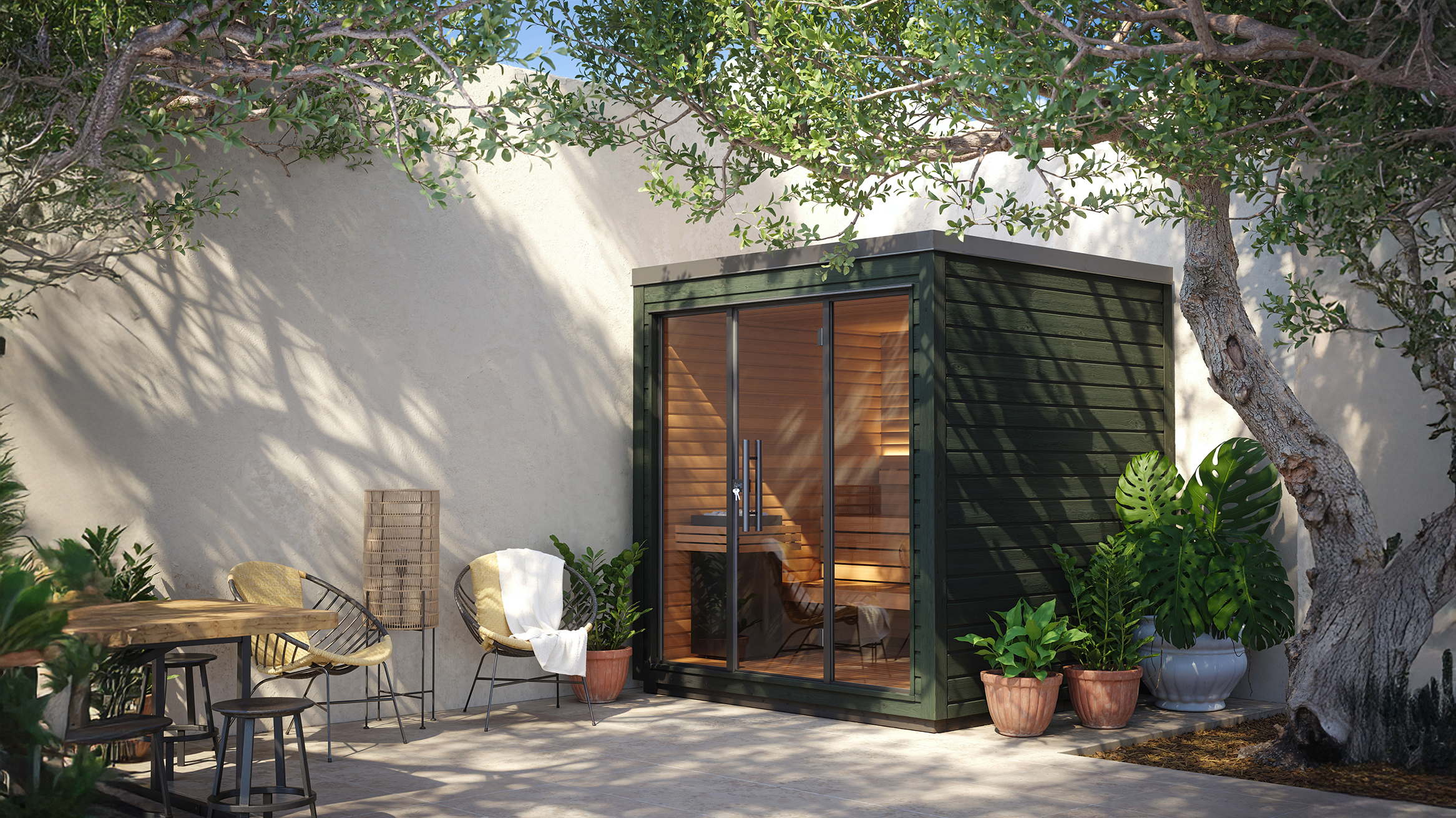 Auroom Mira outdoor sauna with a forest-green exterior, set in a sunny patio with natural greenery and warm wooden interior lighting, showcasing a compact modern wellness design.