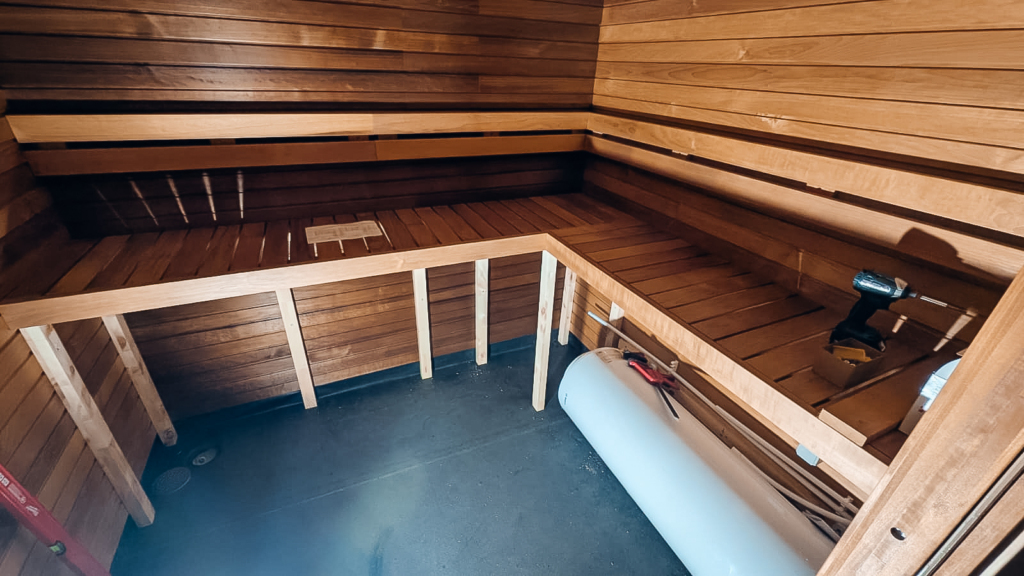 Sauna benches and wooden interior being installed inside the mobile sauna truck during the final assembly phase at Auroom’s workshop.