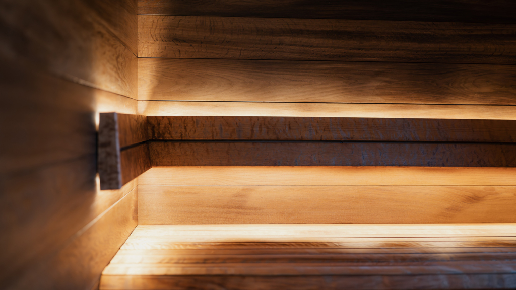 Close-up of Auroom modular indoor sauna bench with integrated lighting and precision-crafted wood panels.