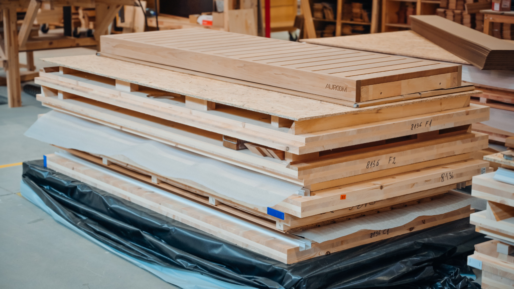 Modular sauna kit with prefabricated wall and bench panels stacked for transport and quick on-site installation