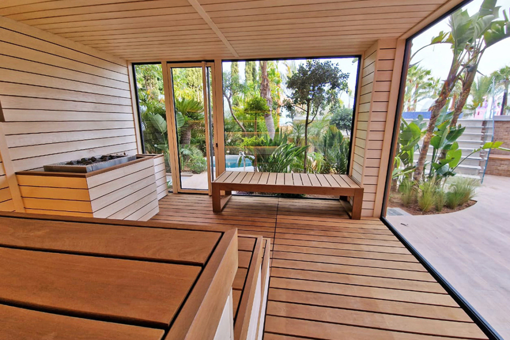 Auroom modular sauna interior with panoramic glass walls designed for warm climate wellness projects in Cyprus.