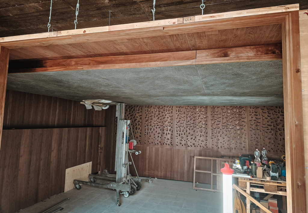 On-site installation of a custom modular indoor sauna with dark wood wall panels and fast assembly process